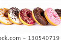 Assorted Colorful Donuts with Sprinkles and Glaze on White Background 130540719