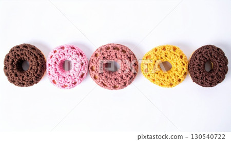 Five Colorful Donuts with Chocolate Sprinkles on White Background in Bright Studio Lighting 130540722