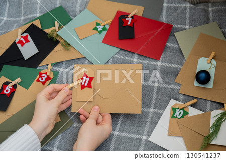 Traditional twenty four days advent calendar before Christmas holidays. Numbers on envelopes Plastic free zero waste sustainable decoration. Winter cozy home Catholic traditions of Christmas countdown Traditional twenty four days advent calendar before Christmas holidays. Numbers on envelopes Plastic free zero waste sustainable decoration. Winter cozy home Catholic traditions of Christmas countdown 130541237