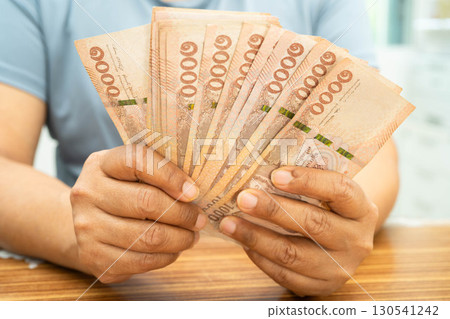 Asian woman counting Thai baht banknote money, investment economy, accounting business and banking. 130541242