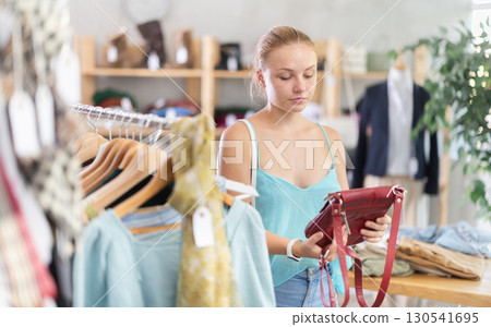 European buyer chooses a handbag in a store European buyer chooses a handbag in a store 130541695