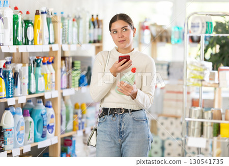Woman scanning dish detergent on her phone 130541735