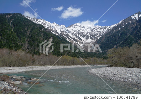 A view of the Azusa River with the snow-capped Hodaka Renzan mountain range visible on a clear day in Kamikochi A view of the Azusa River with the snow-capped Hodaka Renzan mountain range visible on a clear day in Kamikochi 130541789