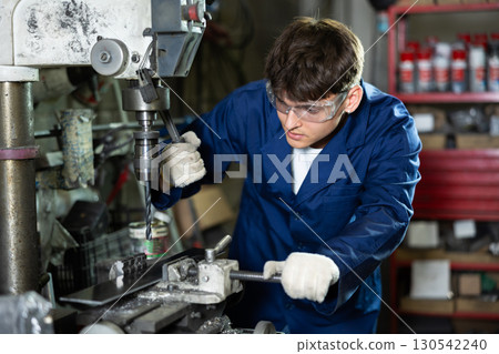 Young guy working with drill machine Young guy working with drill machine 130542240