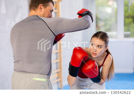 Woman and man boxing in gym Woman and man boxing in gym 130542622