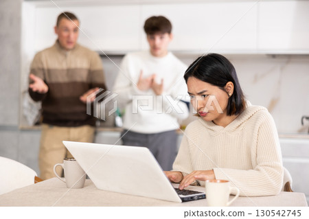Guy and man quarrel with young woman with laptop 130542745