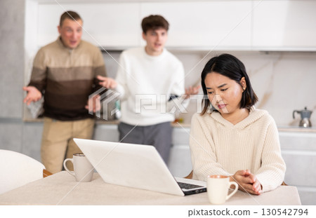 Guy and man quarrel with young woman with laptop Guy and man quarrel with young woman with laptop 130542794