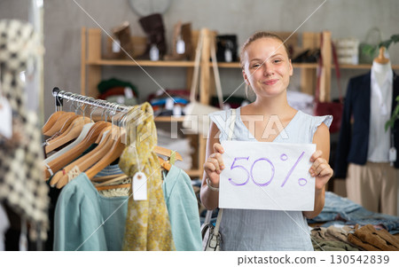 Woman with a sign 50 percentages discount 130542839