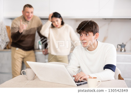 Young woman and adult man quarrel with guy with laptop Young woman and adult man quarrel with guy with laptop 130542849