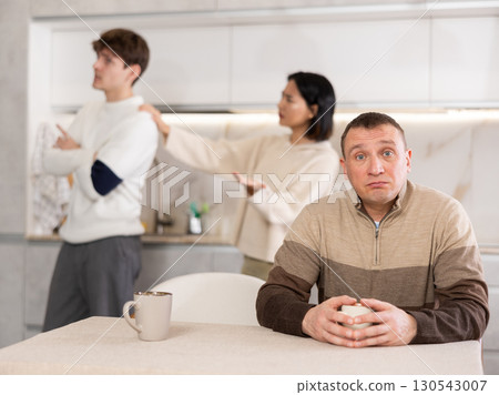 Adult man sad during family quarrel 130543007