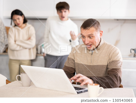 Dissatisfied son and daughter scold their father for playing computer games 130543065