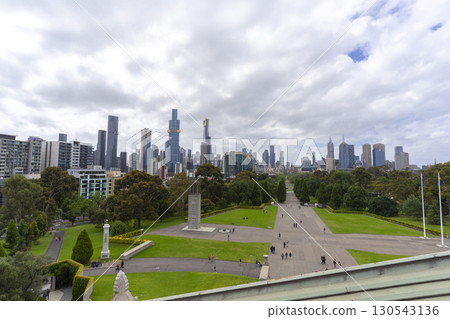 Melbourne, Australia - December 30,2023 : The park pathway leading into the heart of the city looking from the Shrine of Remembrance in Melbourne, Australia on December 30,2023. 130543136