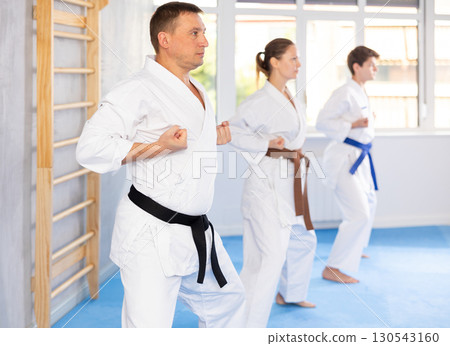 Athletes have starting position and repeating sequence of punches and painful techniques in kata Athletes have starting position and repeating sequence of punches and painful techniques in kata 130543160