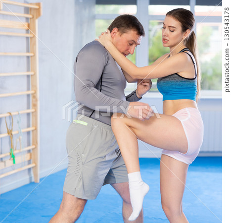 Woman and man practicing self defense techniques 130543178