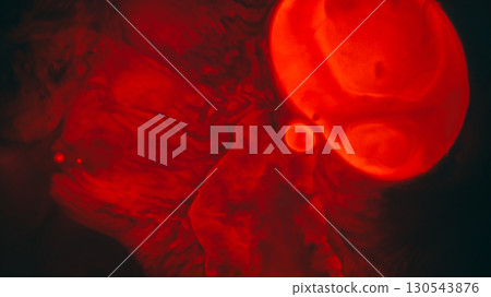 Liquid spot. Stains oil background. Defocused red neon color water splatter paint round flow fluid on abstract dark black texture. Liquid spot. Stains oil background. Defocused red neon color water splatter paint round flow fluid on abstract dark black texture. 130543876