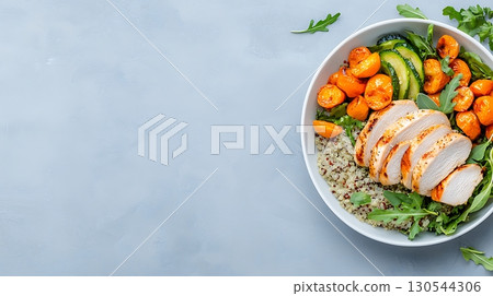 Fresh Grilled Chicken Salad with Quinoa, Roasted Vegetables, and Arugula on Gray Background 130544306