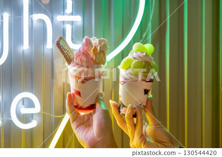 Night ice cream lit up by neon lights 130544420