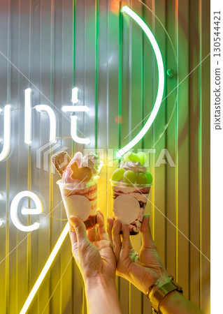 Night ice cream lit up by neon lights Night ice cream lit up by neon lights 130544421