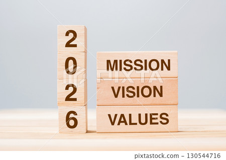 wooden block with text 2026 MISSION, VISION and VALUE on table background. Resolution, strategy, solution, goal, business and New Year holiday concepts 130544716