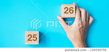 hand holding wooden cube block with 2026 text on blue background. Resolution, plan, review, goal, start and New Year holiday concepts hand holding wooden cube block with 2026 text on blue background. Resolution, plan, review, goal, start and New Year holiday concepts 130544756