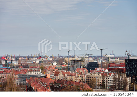 Panoramic view of Gdansk city with port cranes 130545344