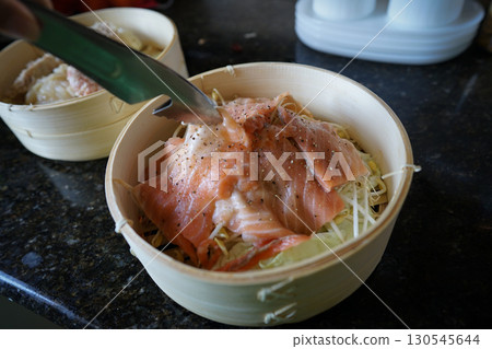 Steamed salmon in a bamboo steamer 130545644