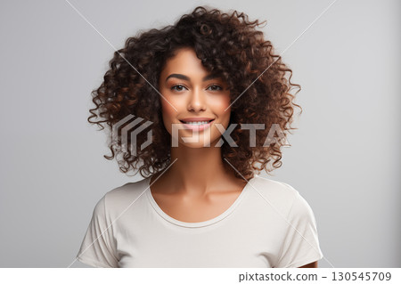 Portrait of a beautiful young woman smiling and looking at camera isolated on a white background Portrait of a beautiful young woman smiling and looking at camera isolated on a white background 130545709