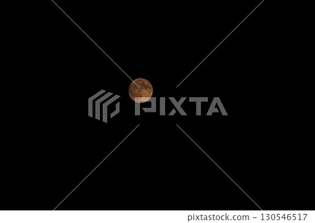 A round moon floating in the night sky A round moon floating in the night sky 130546517