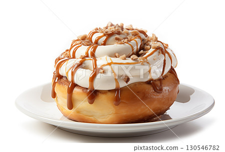 Plate of tasty cinnamon roll with cream on white background 130546782