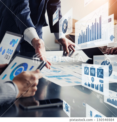 Group of business people in a meeting and business data Square visual for banners and advertisements Group of business people in a meeting and business data Square visual for banners and advertisements 130546984