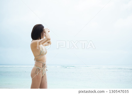 穿著泳衣看海的年輕女子 130547035