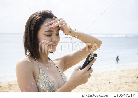 穿著泳衣看海的年輕女子 130547117