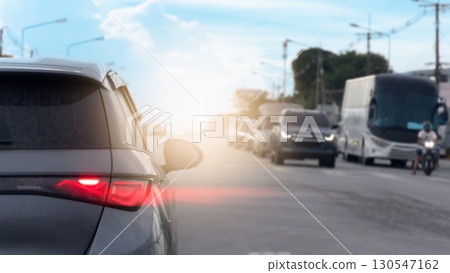 Rear side of car with speed light of brake. on the car with dust of soil all over the surface. Opposite of road with other cars stop in the junction. traffic in the upcountry. Rear side of car with speed light of brake. on the car with dust of soil all over the surface. Opposite of road with other cars stop in the junction. traffic in the upcountry. 130547162