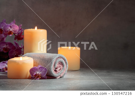 Towels, orchid flowers, and burning candles. Towels, orchid flowers, and burning candles. 130547216