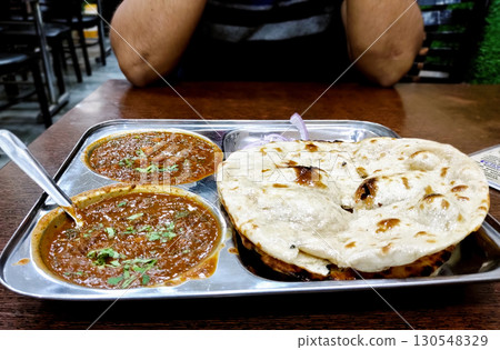 Indian Restaurant Meal with Naan and Curry Indian Restaurant Meal with Naan and Curry 130548329