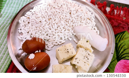 Traditional Indian Sweets and Offerings on a Steel Plate Traditional Indian Sweets and Offerings on a Steel Plate 130548330