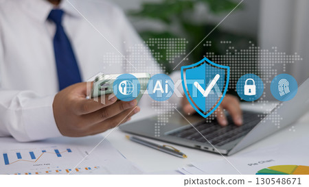 usinessman Using Smartphone and Laptop with Cybersecurity AI Technology Icons for Data Protection 130548671