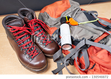 Bear spray, a loud whistle, a backpack, and hiking boots. 130548872