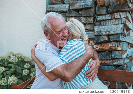 Happy senior couple embracing, spending time together during retirement. Happy senior couple embracing, spending time together during retirement. 130549578