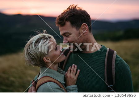 Portrait of romantic couple in nature during sunset. 130549650