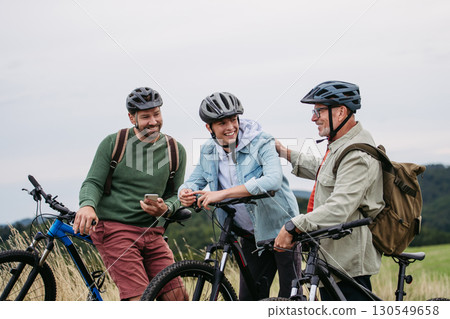 Grandfather, father and teen boy on cycling trip. 130549658