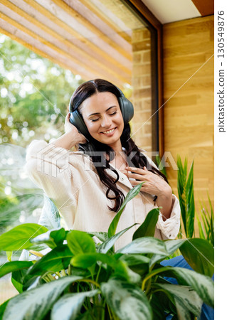 Relaxed woman enjoying free time, listening to music. Relaxed woman enjoying free time, listening to music. 130549876