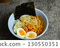Shrimp ramen with boiled egg, corn, and nori. A delicious and savory Asian noodle soup, perfect for a hearty meal. 130550351