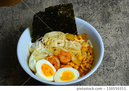 Shrimp ramen with boiled egg, corn, and nori. A delicious and savory Asian noodle soup, perfect for a hearty meal. Shrimp ramen with boiled egg, corn, and nori. A delicious and savory Asian noodle soup, perfect for a hearty meal. 130550351