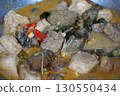 Authentic Ikan Pe, a traditional Indonesian dish from Surabaya, East Java. Smoked stingray curry with rice cake, tofu, and vegetables in rich coconut milk. 130550434