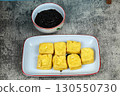 Tahu goreng or Fried tofu with petis or black shrimp paste dipping sauce, a popular Indonesian snack from Surabaya, East Java. 130550730