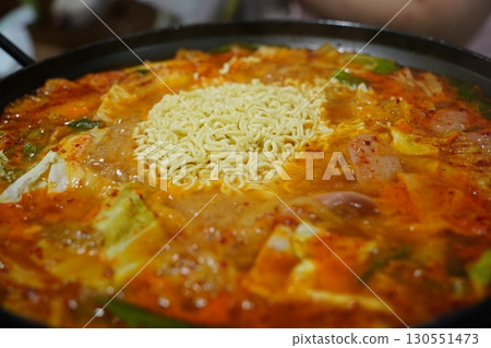 Closeup of Korean Army Stew Budae Jjigae with Noodles and Sausage 130551473