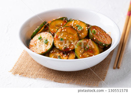 Korean cucumber salad (Oi muchim) in bowl on white background, Korean side dish 130551578