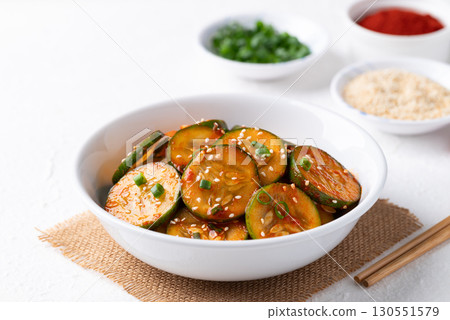 Korean cucumber salad (Oi muchim) in bowl on white background, Korean side dish 130551579