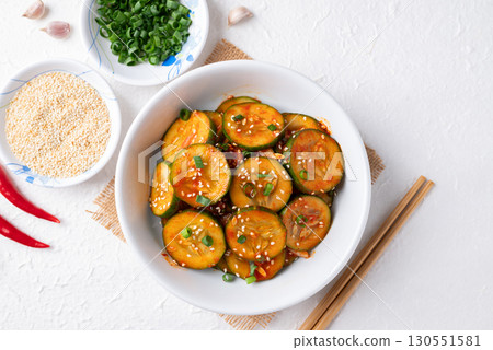 Top view of Korean cucumber salad (Oi muchim) in bowl on white background, Korean side dish 130551581